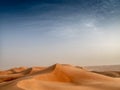 The dunes of the Wahiba Sands desert in Oman at sunset during a