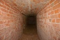 Dungeon. Underground passage, tunnel, arch laid out red brick