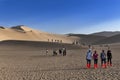 Group of Chinese tourists at the Crescent Moon Lake near the city of Dunhuang, in the Gansu Province, China. Royalty Free Stock Photo