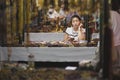 Dunhuang, China - 08 06 2016: A chinese craftswoman selling souvenirs at Shazhou Market, a night market in Dunhuang