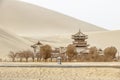 DUNHUANG,CHINA-MARCH 11 2016: Temple at Mingsha shan Gobi desert, sand mountain and Crescent moon lake in Dunhuang, silk road at Royalty Free Stock Photo