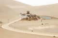 DUNHUANG,CHINA-MARCH 11 2016: Temple at Mingsha shan Gobi desert, sand mountain and Crescent moon lake in Dunhuang, silk road at Royalty Free Stock Photo