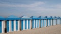 Dunkerque, France: Blue and white striped beach huts on the sand on the sea front at Malo-Les-Bains beach in Dunkirk.