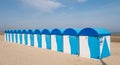 Dunkerque, France: Row of blue and white striped beach huts on the sea front at Malo-Les-Bains beach in Dunkirk