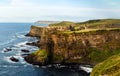 Dunluce Castle on the cliff in Bushmills, sunset Royalty Free Stock Photo