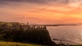 Dunluce Castle on the cliff in Bushmills, sunset Royalty Free Stock Photo