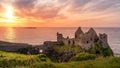 Dunluce Castle on the cliff in Bushmills, sunset Royalty Free Stock Photo