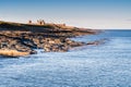 Dunstanburgh Castle from Craster Harbour Royalty Free Stock Photo