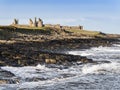 Dunstanburgh Castle on the Northumberland coast with copy space Royalty Free Stock Photo