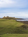 Dunstanburgh Castle on the Northumberland coast with copy space Royalty Free Stock Photo