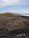 Dunstanburgh Castle on the Northumberland coast with copy space Royalty Free Stock Photo