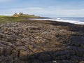 Dunstanburgh Castle on the Northumberland coast with copy space Royalty Free Stock Photo