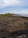 Dunstanburgh Castle on the Northumberland coast with copy space Royalty Free Stock Photo