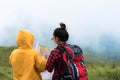 Duo female hiker with backpack reading and searching map while w