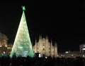 The Duomo of Milan at Christmas time, with the typical lighted tree in the middle of the square Royalty Free Stock Photo