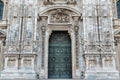 Duomo of Milan, Italy. Detail of facade and main entrance door to the cathedral of Milan in Duomo Square Royalty Free Stock Photo