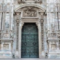 Duomo of Milan, Italy. Detail of facade and main entrance door to the cathedral of Milan in Duomo Square Royalty Free Stock Photo