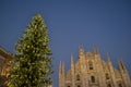 Duomo square of Milan decorated with the Christmas tree and the cathedral at sunset. Royalty Free Stock Photo