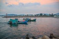 Duong Dong city, Phu Quoc, Vietnam - December 2018: ships in the sea near harbor with breakwater, beautiful clouds, sunset.