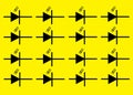 Duplicates of an electrical electronic symbol sign of a Photodiode bright yellow backdrop Royalty Free Stock Photo