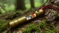 Durable brass survival tool featuring an integrated compass and glowing light resting on forest moss Royalty Free Stock Photo