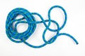 durable colored rope for climbing equipment on a white background. knot of braided cable. item for tourism and travel Royalty Free Stock Photo