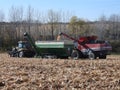 Challenger MT765D tractor pulling a Killbros 1820 grain cart being loaded from a Massy Ferguson 9540 combine harvester in norther