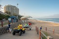 Surf rescue Lifeguard on quad bike towing a jetski, onto the promenade near the beach at Umhlanga Rocks Royalty Free Stock Photo