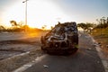 Durban, South Africa, 14 July 2021. Sunset behind a car damaged during a protest.