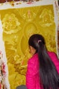 Young woman painting a thanka, a Tibetan Buddhist religious painting, Durbar Square, Bhaktapur, Nepal