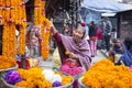 DURBAR SQUARE, KATHMANDU, NEPAL - NOVEMBER 10, 2017: Woman selling flower garlands for prayer at street market in Kathmandu, Nepal Royalty Free Stock Photo