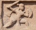 Durg, Chhattisgarh, India - January 18, 2009 Ancient stone bas relief of a warrior with a sword and a shield