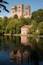 Durham England: 2022: Durham Cathedral exterior during sunny summer day. View from river wear with lush green trees