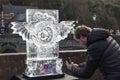 Man taking photographs on a mobile phone camera at ice sculpture festival