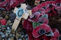 Poppy wreaths and small wooden cross woth frost at the Durham Light Infanry memorial