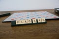 Scrabble board game. Spelling word play, making words out of tiles on square board Royalty Free Stock Photo