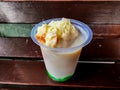 Durian Cendol Ice Drink topped with grated cheese and slices of bread