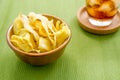 Durian chips fried snack fruit in brown blow on green background