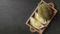 Durian fruit in wooden tray on black background. Durian is king of fruits. AI Generated Royalty Free Stock Photo