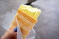 Durian Ice Cream in a waffle in a woman`s hand, made of Durian Durio, asian fruit having strong, smelly odour