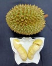 Durian and peeled raisins contained in a white plate on a black background Royalty Free Stock Photo