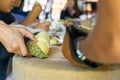 Durian Seller are showing how to open and explain informations and details to audiences about type of durain on the lunch table Royalty Free Stock Photo