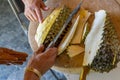 Durian Seller are showing how to open and explain informations and details to audiences about type of durain on the lunch table Royalty Free Stock Photo