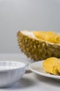 Durian sticky rice with sugar and coconut milk against blurry durian fruits background. selective focus