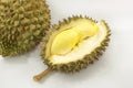 Durian on a white plate with green spike rind and white backgro