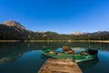 Durmitor National Park - Mountain lake Black Lake `Crno jezero` with wooden boats and reflections of mountain range in clear water Royalty Free Stock Photo