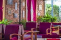 Interior of a cozy urban cafe with soft comfortable chairs in red colors with brick walls