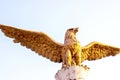 DUSHANBE, TAJIKISTAN - JULY 2, 2022: The statue of golden Brazen Eagle against the sky. Royalty Free Stock Photo