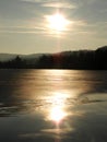 Dusk sunset arrives on frozen Little York Lake during winter