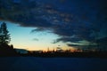 Dusk and clouds over winterly road in Swedish Lapland